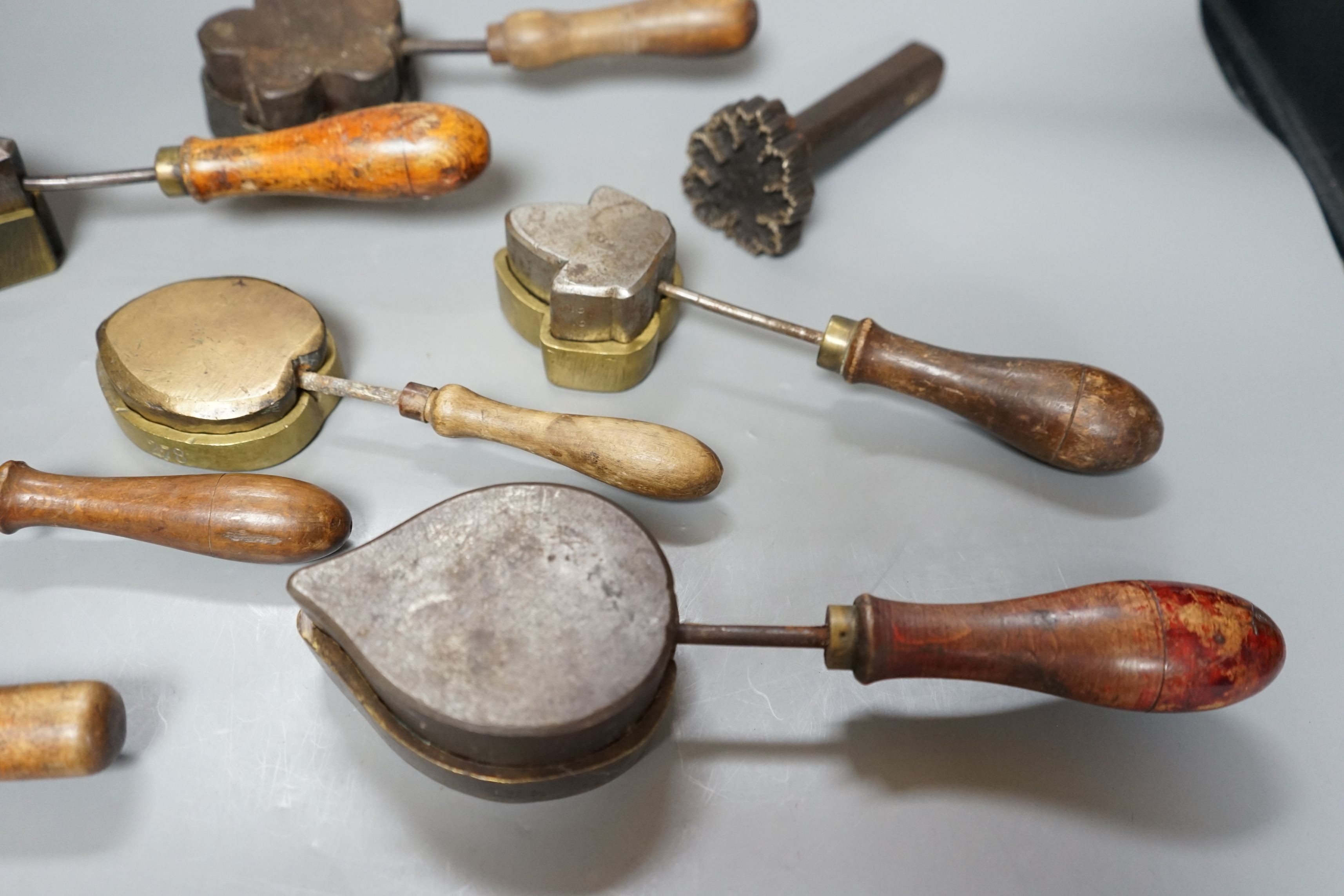 A collection of eight 19th century cast metal floral moulds, possibly for embossing silk